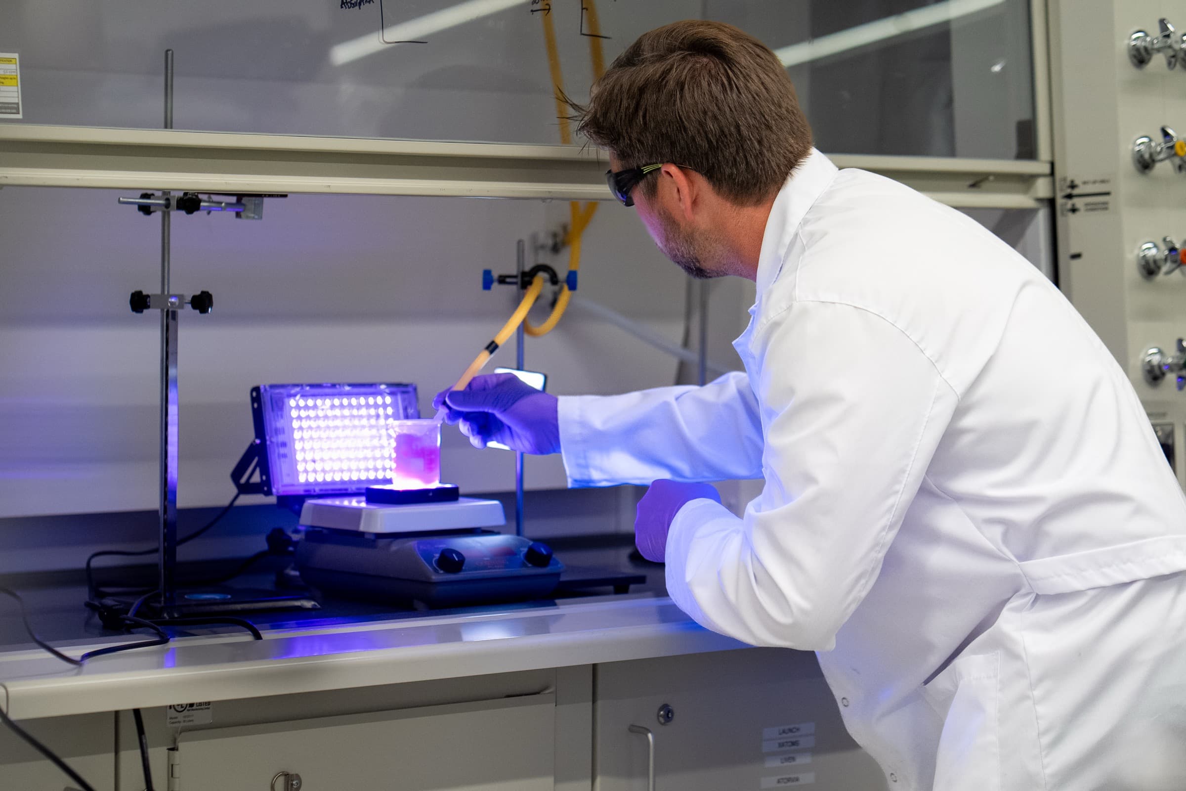 Xatoms researcher working at an LED light test setup in the lab